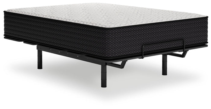 Limited Edition Plush innerspring mattress with black quilted sides and gray top on adjustable bed frame