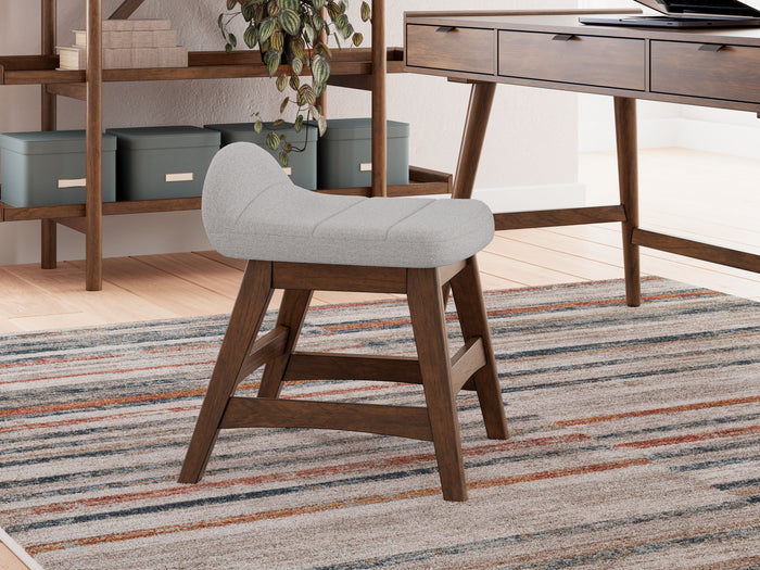 Lyncott light gray desk chair with brown wood legs and base on striped area rug - Bel Furniture