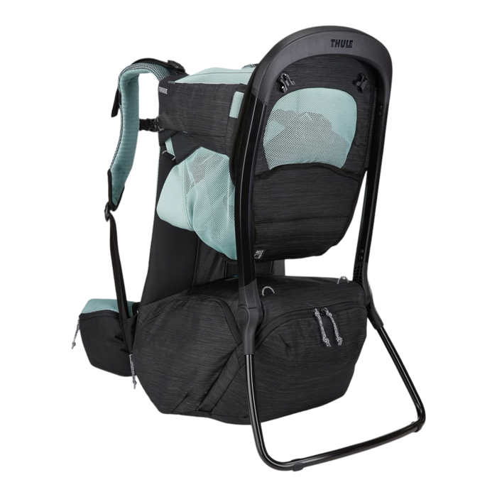 A Thule baby carrier backpack in black and light teal, shown from a three-quarter rear view against a solid white background.