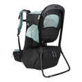 A Thule baby carrier backpack in black and light teal, shown from a three-quarter rear view against a solid white background.